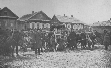 several men and wagons lined up along a street