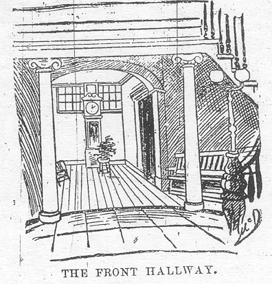A hall with columns and a sweeping staircase to the right labeled The front hallway.