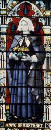 stained glass window of Anne Bradstreet standing with basket in her hands