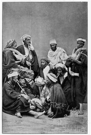 a group of men in cloaks and turbans seated together