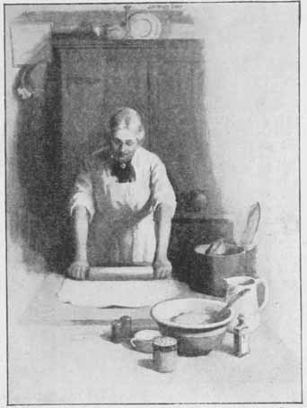 a woman rolling out dough in a kitchen