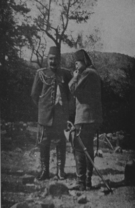 photograph of the two men , one has a large axe on his hip.