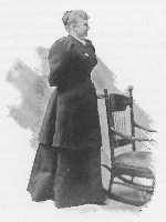 woman in long dress standing next to a rocking chair