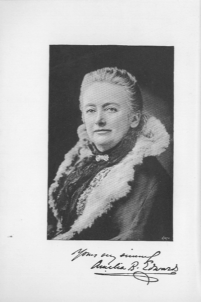 portrait, black and white signed photograph of the author wearing a fur trimmed coat and smiling.