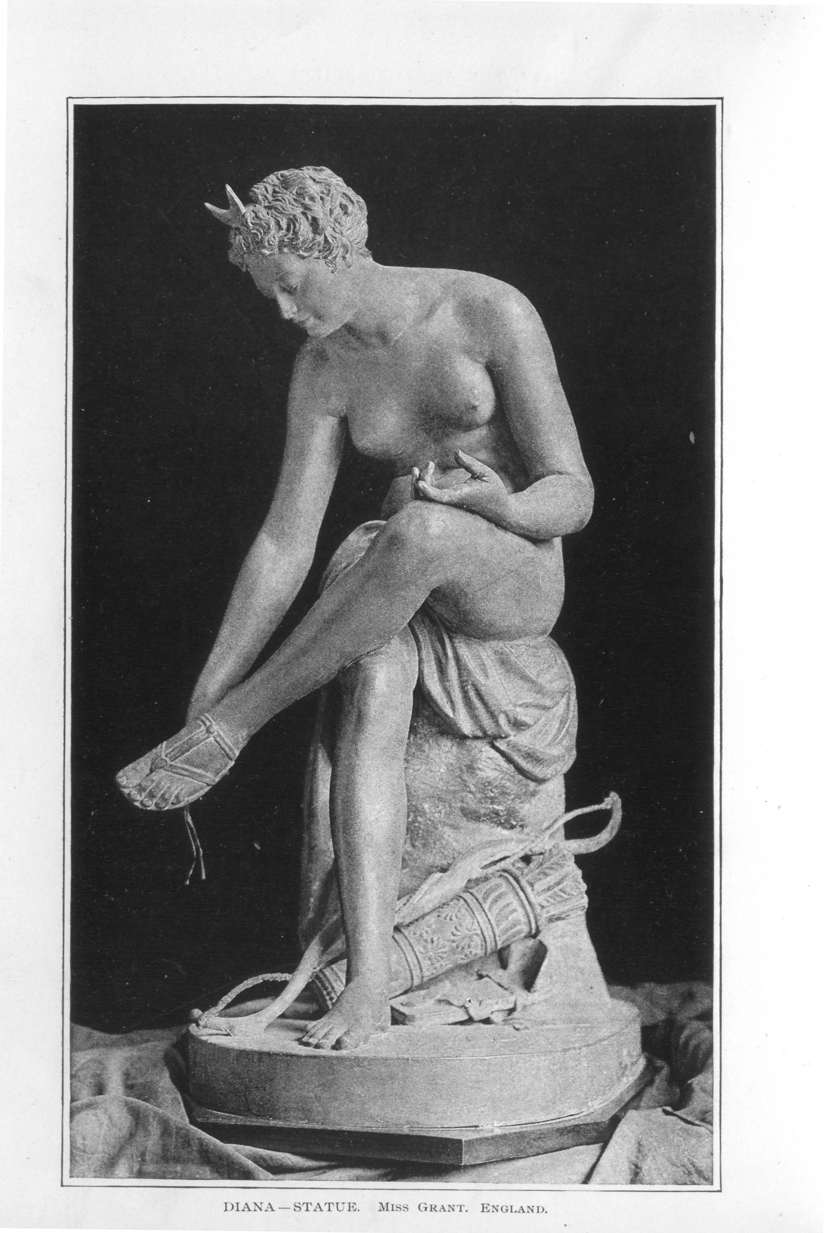 nude statue of Diana sitting with her bow and quiver full of arrows by her feet
