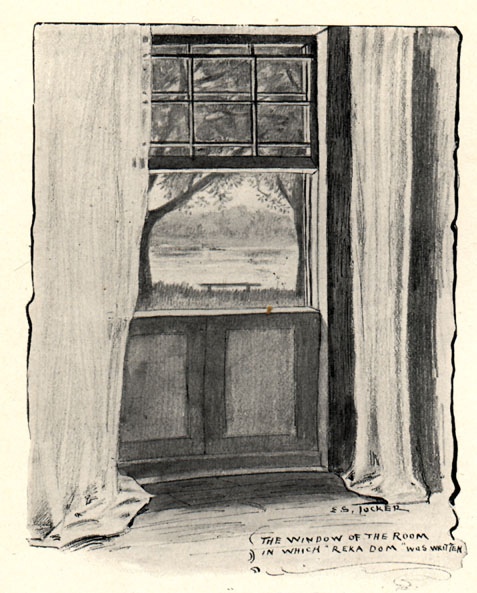 open window with curtains and view of bench on a river; text: The window of the room in which 'Reka Dom' was written