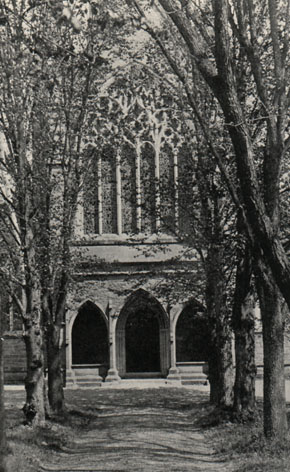 cathedral entrance at the end of a tree-lined path