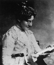 photograph of woman with glasses reading