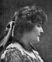 photograph of a woman in profile with feathers in her hair