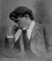 Photograph of man in profile resting head on right hand