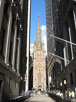view of church between taller buildings