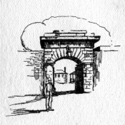 Detail of an arched brick entryway being guarded by a man in uniform.