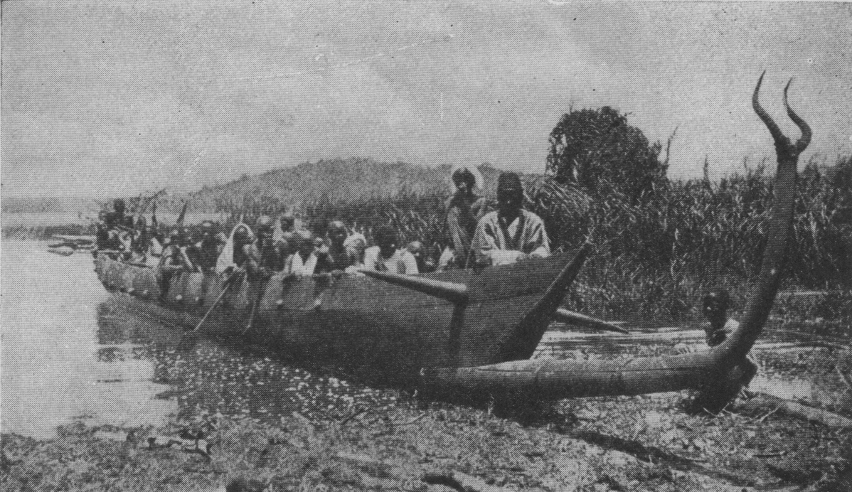 long boat with protrusions on bow and many people aboard