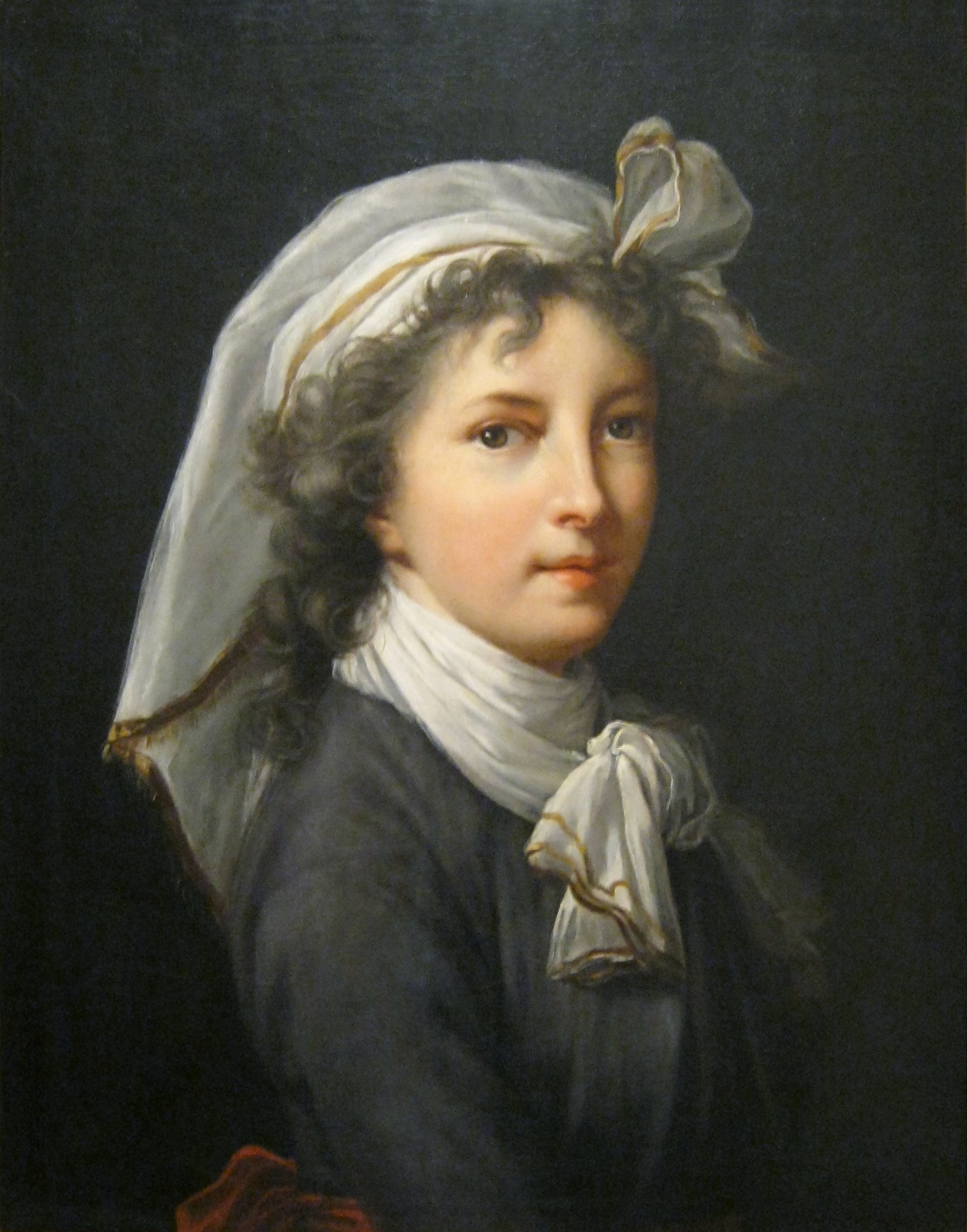 Self portrait showing woman wearing a headscarf and neckerchief