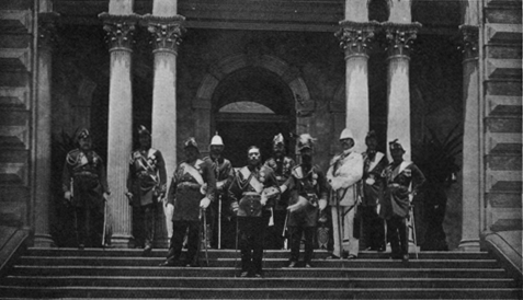 men in military garb standing on steps of building with columns
