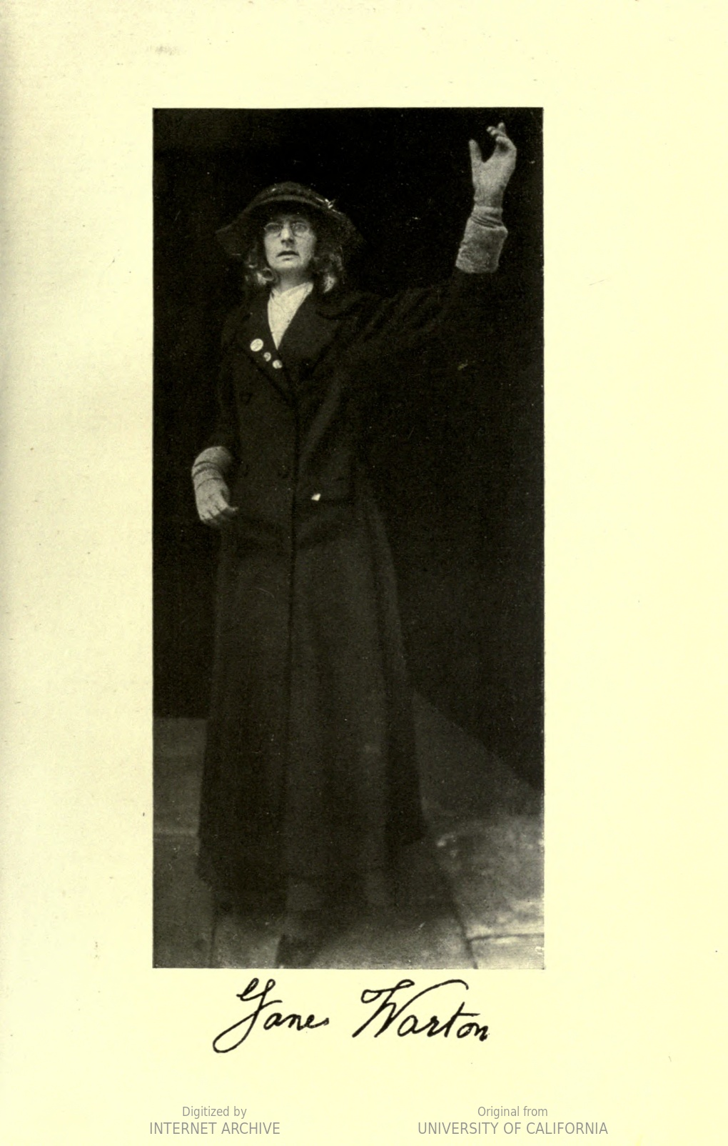 woman in hat, gloves, glasses, and dark jacket with left arm raised. Signed 'Jane Warton'.