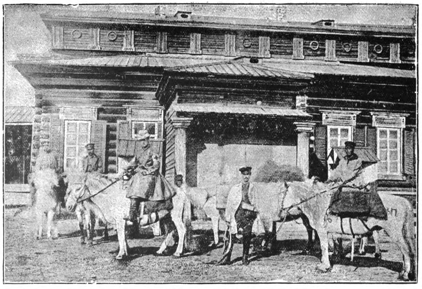 woman and several men on horses in front of a building