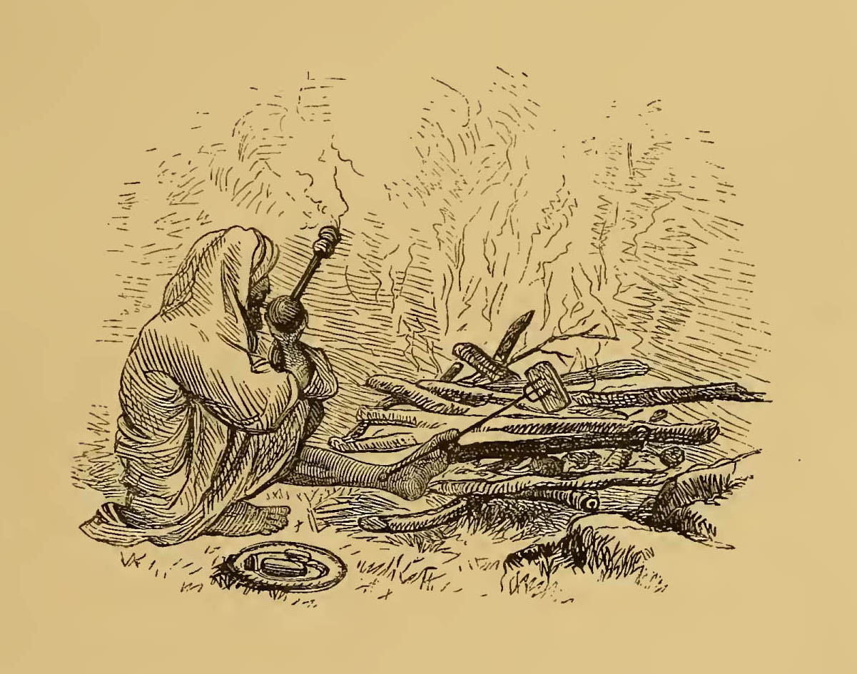 man cooking over fire