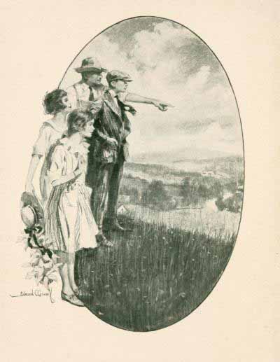 man, boy, and two girls standing in country meadow, the man points at something in distance