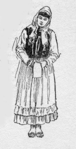 Woman wearing skirt with apron, jacket, and head scarf.