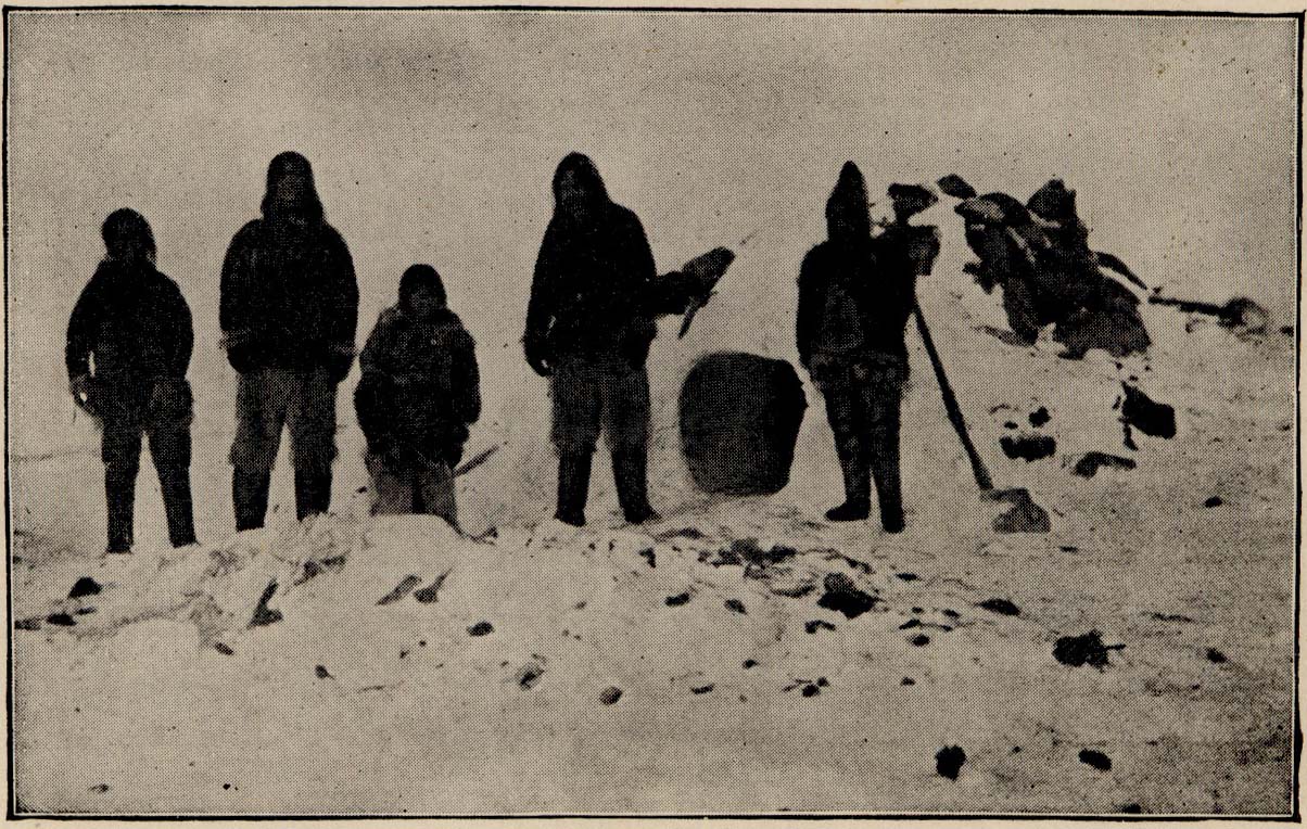 A number of people are standing outside the entrance to a Snow House.