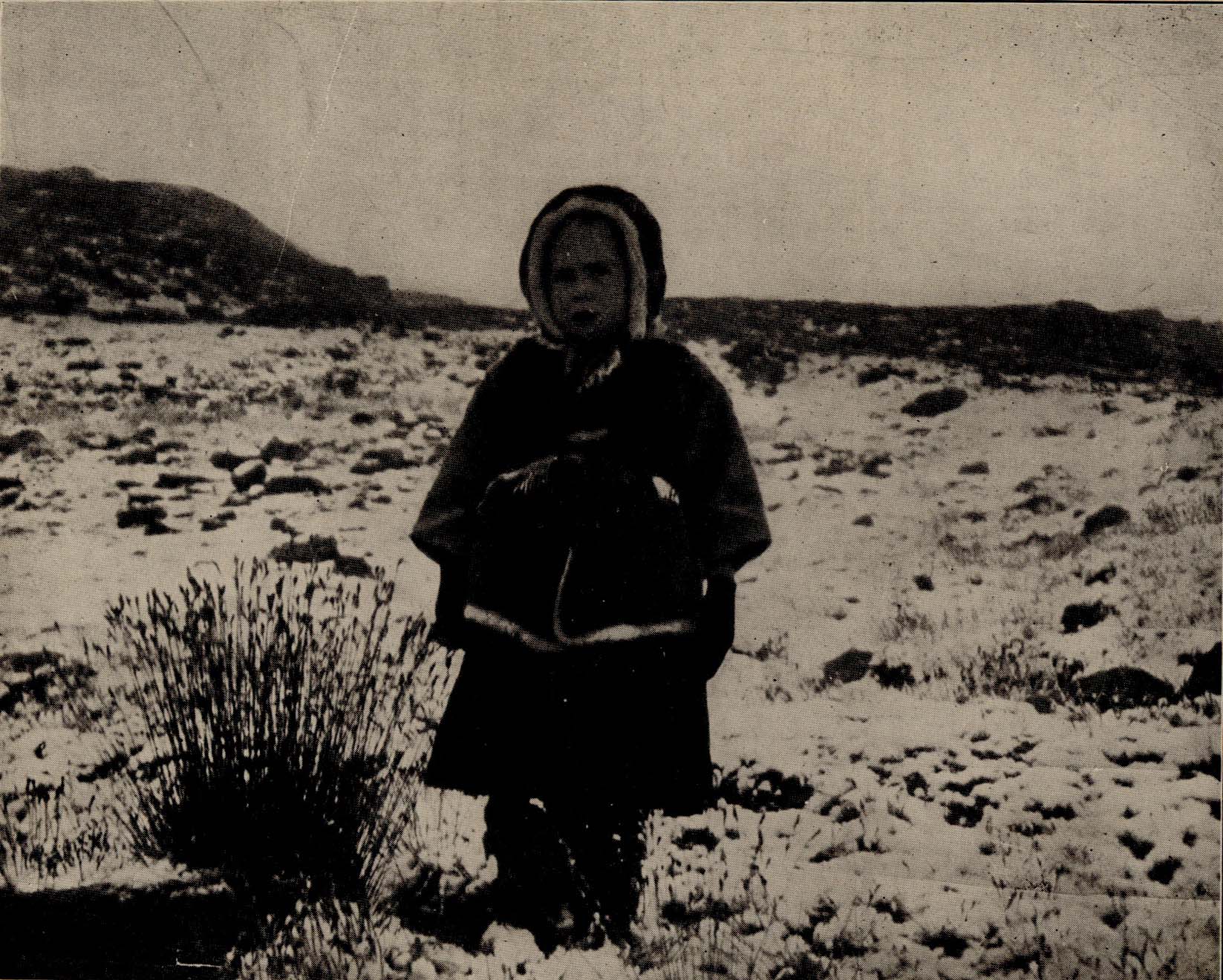 Child standing outside.