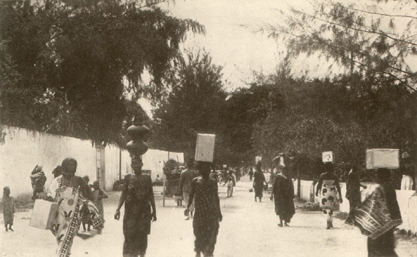 women walking with containers of water on their heads