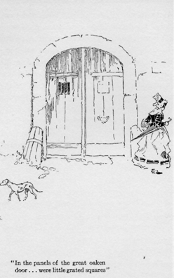 Large rounded door with a dog in front of it.