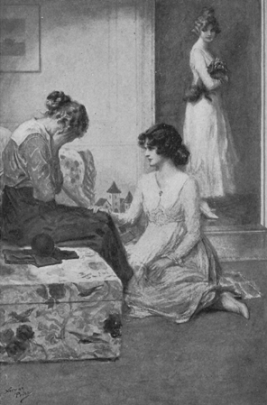 woman kneeling on floor comforting seated woman crying as another woman holding a small dog looks on from doorway