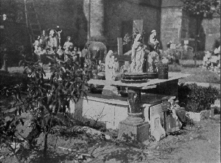 religious statues atop stone grave