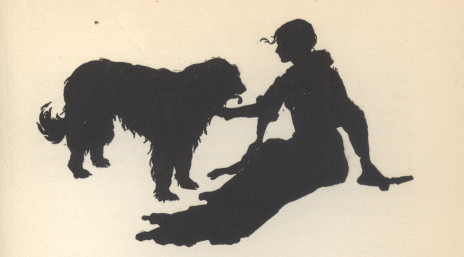 The shilhouette of a young woman sitting with a large dog.