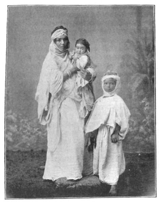 woman standing near a child and holding a baby in her arms