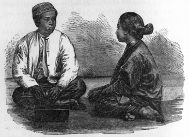 young man and woman seated facing eachother