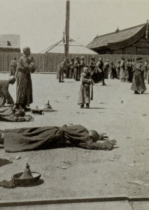 monks laying facedown on the ground in worship