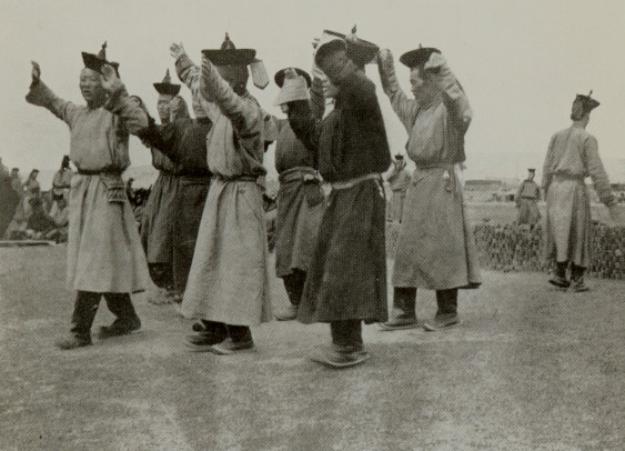 group of men chanting with their hands above their heads