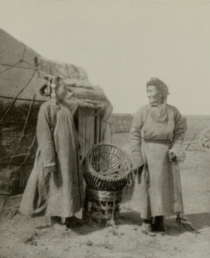 older Mongolian man standing with woman, a large basket rests between them
