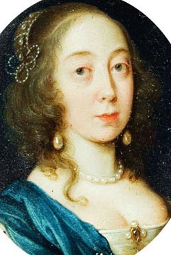 woman with pearl jewelry and hair adornment wearing fine blue dress