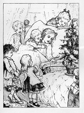 A girl lies in a bed surrounded by other children with a small Christmas Tree sitting on a chair next to her.