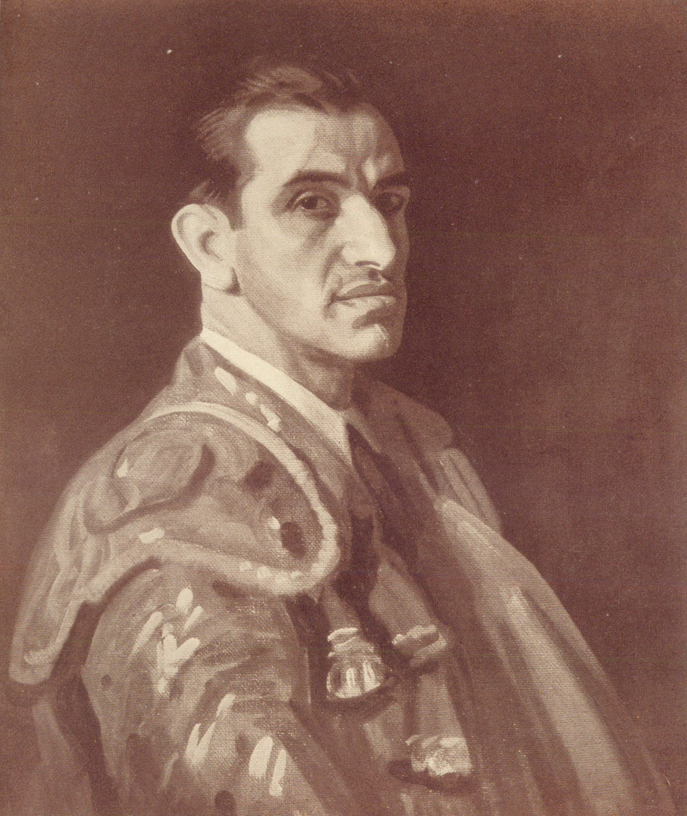 three quarter profile portrait of the fighter in his fighting costume. he has a powerful gaze.