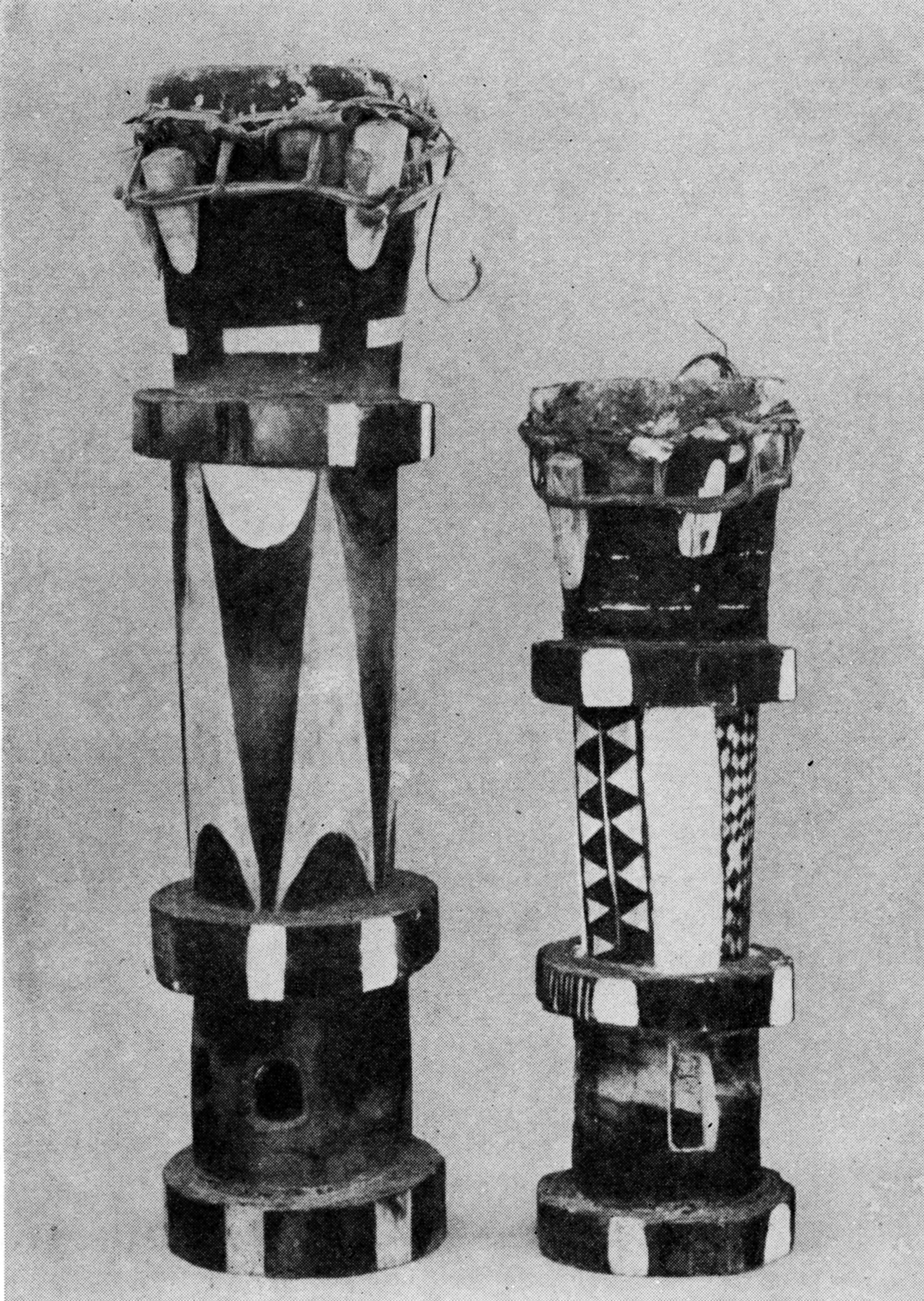 photograph of two tall slender drums decorated in black and white