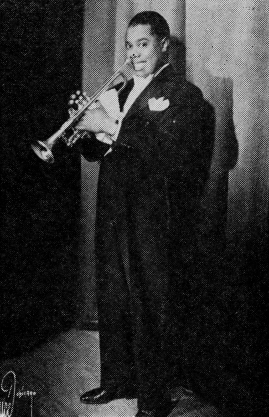 photograph of Louis Armstrong holding his trumpet