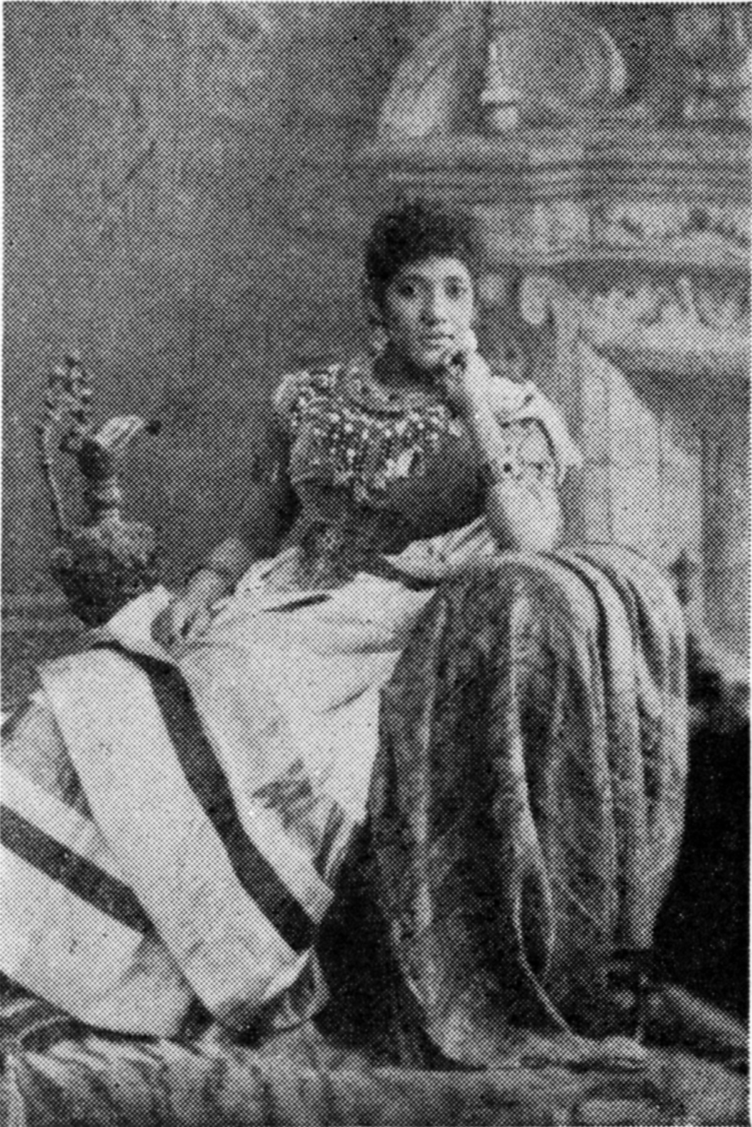 photograph of Madame Selika seated in a luxurious room and wearing a rich, luxurious dress.