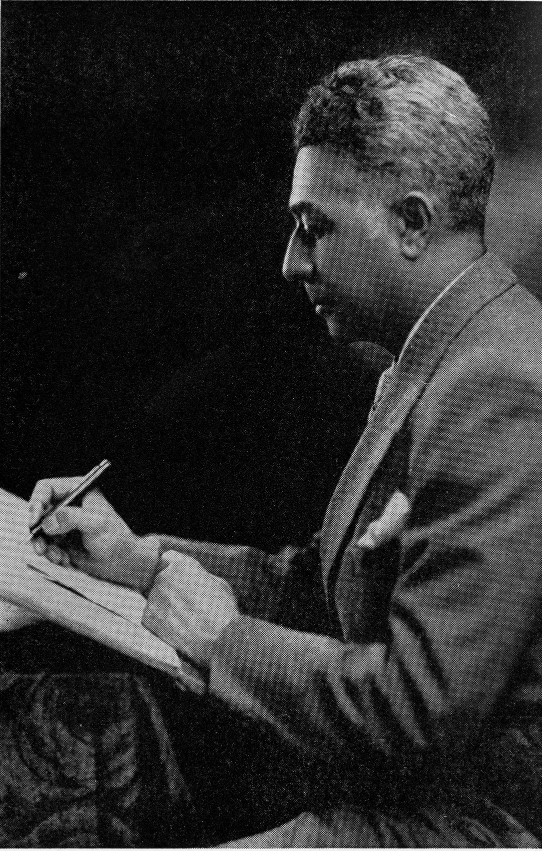 photograph of Clarence Cameron White writing