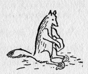 fox sitting with rocks