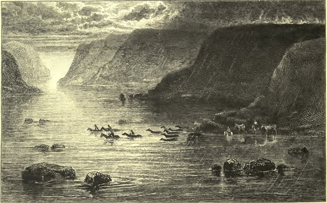 horses and people on horseback crossing through the water between the large beautiful, flat-topped rocks. a gorgeous suffusion of light can be seen coming thorough the clouds onto the water.
