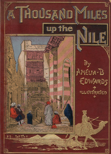 cover, with gold printing and an image of a street scene with pink buildings, a blue sky, and four turbaned men