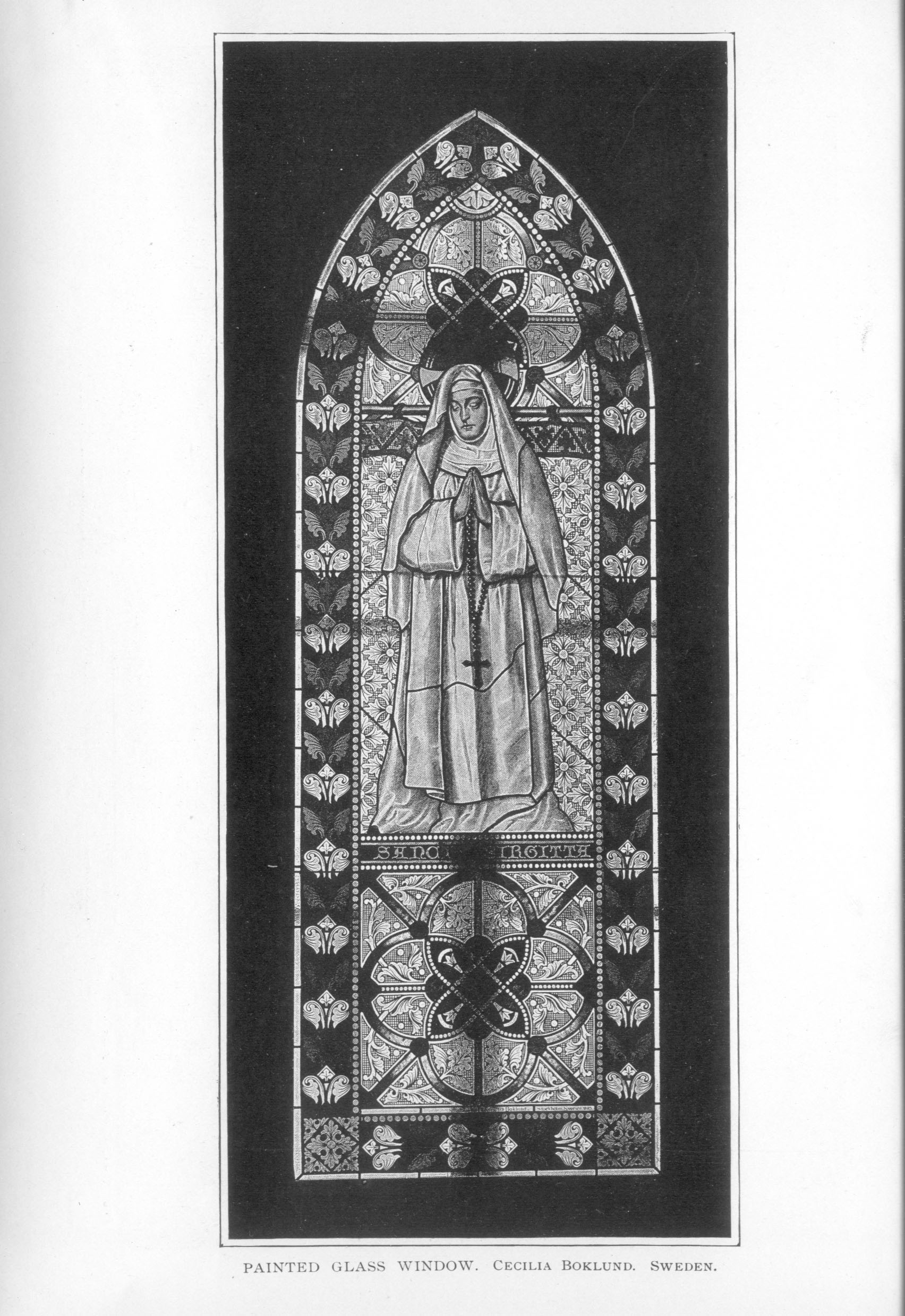 stained glass window decorated with a praying nun wearing a rosary