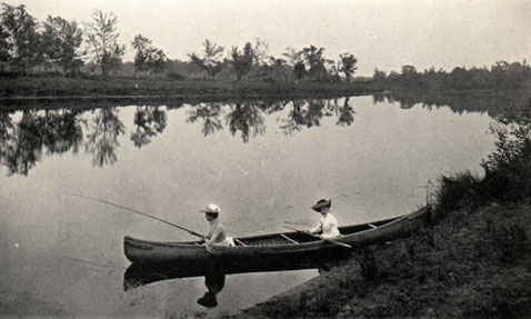 two people fishing in a canoe on a river