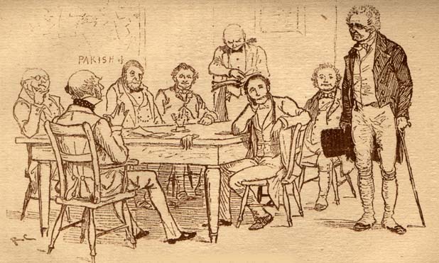 Old man standing in front of a table surrounded by several seated men.