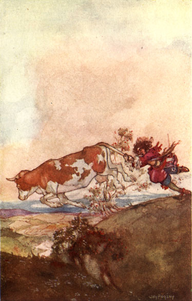 soldier holding on to a cow's tail as it runs through the hills